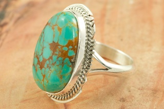 Genuine Manassa Turquoise set in Sterling Silver Ring. This Turquoise is also referred to as King�s Manassa Turquoise. The Manassa Turquoise mine is located in Manassa, Conejos County, Colorado. Created by Navajo Artist Larson Lee. Signed by the artist.